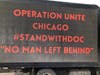 Sign truck parked at rally to demand rehiring of Queen of Martyrs principal who defied mask mandate. 