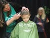 Third-grader Jake Moran gets his head shaved for childhood cancer research during Southwest Elementary School's St. Baldrick's head-shaving event. 