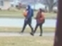 A man in a blue jacket, believed to be involved in a violent home invasion of an elderly homeowner in Oak Lawn, is seen walking with the female suspect. 