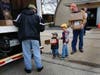 St. Bernadette parishioners, Evergreen Park Fire Department and community volunteers  load 600 boxes of medical and survival items into a 25-ft. moving truck