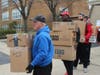 St. Bernadette parishioners and community volunteers load 600 boxes of medical and survival items into a 25-ft. moving truck