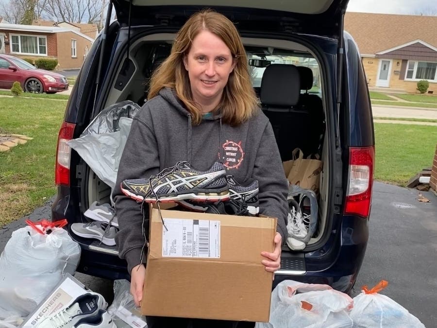 Renee Copeland, vice president of Christmas Without Cancer, picks up another used sneaker donation for the organization's "Got Sneakers" fundraiser campaign.