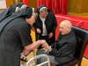 Fr. Albert Adamich greets wellwishers on his 100th birthday at Most Holy Redeember.  