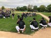 Sullivan's grandchildren, Mason, Rosie, Caitlin and Chloe, throw pitches to current Spartan players at the dedication of Skip Sullivan Field at Oak Lawn Community High School.
