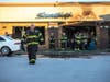 Oak Lawn firefighters battle a blaze at a hair salon after a car drove through the building. 