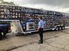 A Chicago police officer stands in front of the photo-wrapped trailer of the Beyond The Call of Duty mobile memorial.