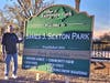 Former Mayor James Sexton stands next to the new sign designating the former 50-Acre Park that was renamed in his honor.