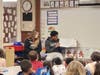 Evergreen Park Community High School book buddies Taylor Evans (left) and Jonatthan Whiteside read a story to Southwest Elementary School first-graders. 