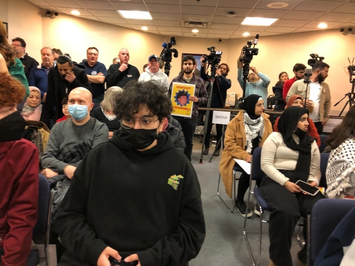 Protesters from the Arab American Action Network and supporters of the Oak Lawn police crowd village hall before the fire and police commission meeting. 