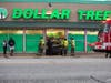 Customers and employees congregate in front of Dollar Tree after a car plowed into the building Monday afternoon. 