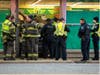Oak Lawn first responders congregate around a car after it plowed into Dollar Tree Monday afternoon at 105th Street and Cicero Avenue in Oak Lawn. 