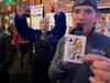 Misty McMichael, wife of Bears HOF Steve "Mongo" McMichael, and At The Office owner Tim Newsome hold the queen of spades in Park Lawn's Queen of Hearts Raffle drawing.