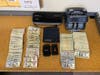 Police found guns and drugs in a 21-year-old man's home while he was on electronic monitoring, the Cook County Sheriff said. 
