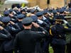 Chicago police officers salute the casket of Officer Huesca as it's carried into St. Rita of Cascia Shrine Chapel.