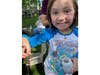 Ava S., 7, shows off Bluey, a rare blue-eyed cicada she found at a friend's birthday party near Covington School in Oak Lawn. 