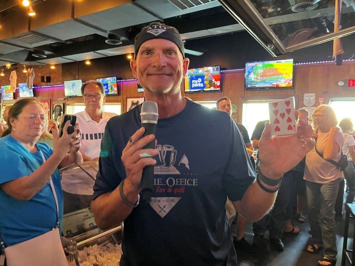 The irrepressible Tim Newsome, owner of At the Office Sports Bar & Grill in Crestwood where the Park Lawn Queen of Hearts Raffle is pulled every Wedneday, holds the 9 of hearts card in the June 5 drawing. 