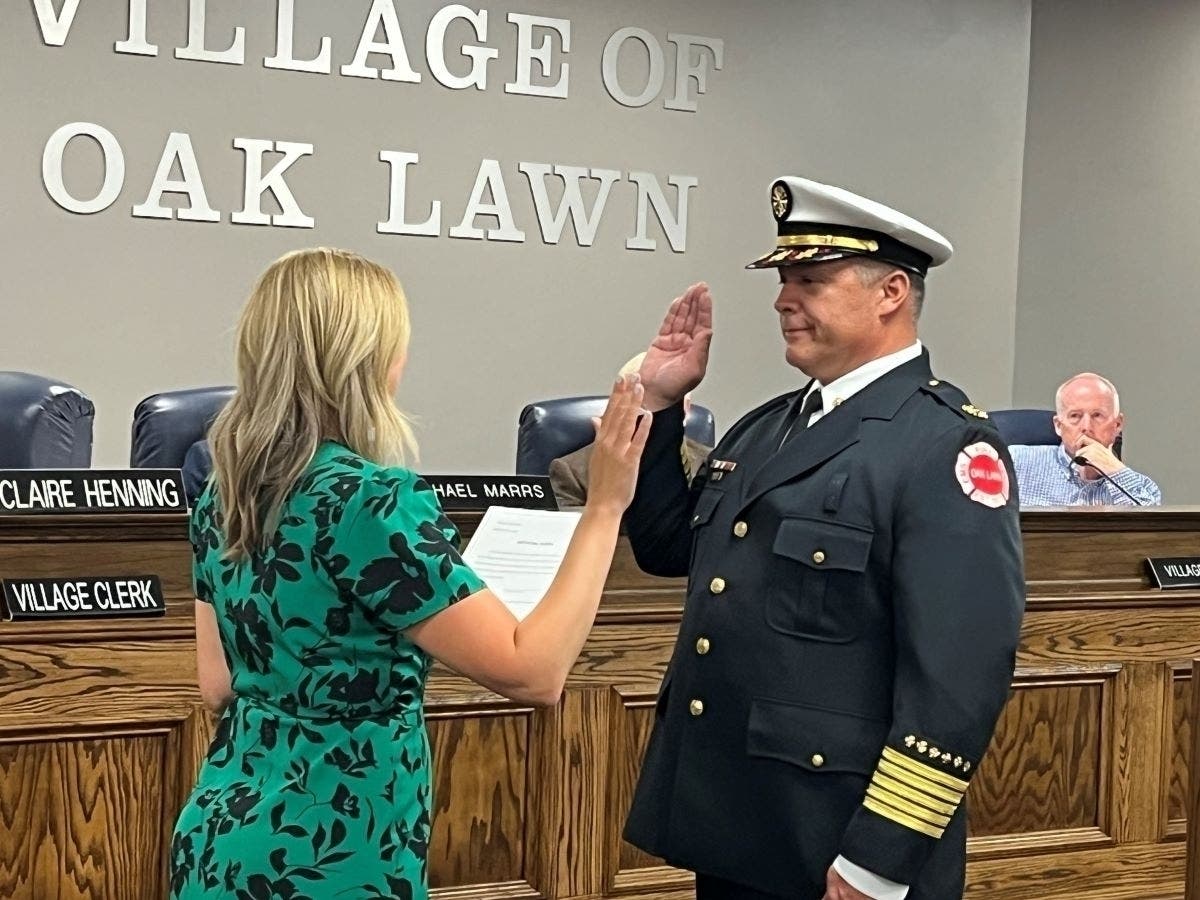 Oak Lawn Village Clerk Claire Henning swears in Michael McMillin as chief of the Oak Lawn Fire Department. 