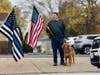 A community member waits on 103rd Street for the procession from Blake-Lamb to St. Rita.