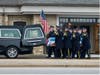 A Chicago police honor guard load the casket of fallen Officer Enrique Martinez into a hearse out of Blake-Lamb Funeral Home in Oak Lawn. 