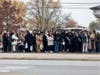Family members of Officer Enrique Martinez stand in front of Blake-Lamb for the procession to St. Rita of Cascia Shrine Chapel. 