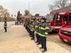 Oak Lawn firefighters salute the passing casket of CPD Officer Enrique Martinez at the 103rd Street fire station. 