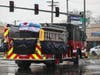 A Chicago fire engine carries the Chicago-flag-draped casket for CFD FF-EMT Michael Altman to Holy Sepulchre Cemetery. 