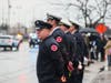 Chicago firefighters line up in the rain to salute their fallen colleague. 