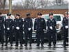 Chicago firefighters line up in the rain to salute their fallen colleague. 