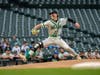 Oak Lawn senior John Olejniczak made his season debut on the mound after suffering a knee injury early in the football season, hurling a 1-2-3 first inning in Sunday's IHSA game against Reavis at Wrigley Field. 