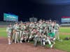 Dirty but happy: the Oak Lawn Community High School baseball team celebrates its comeback win in an IHSA high school game against Reavis at Wrigley Field. 