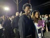Parents posed proudly with their graduates for the Trinity Christian College “farewell party” in the parking lot at Ozinga Field in Crestwood. 