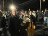 Parents posed proudly with their graduates for the Trinity Christian College “farewell party” in the parking lot at Ozinga Field in Crestwood. 