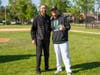Oak Lawn Community High School athletic director Jeremy Cryan presents a commerative ball to Spartan skipper Bill Gerny after his 200th win as a coach. 