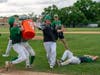 Players dump a bucket of water on OLCHS Head Baseball Coach Bill Gerny, who recently earned his 200th win as a coach, after beating Reavis earning a trip to the IHSA playoffs.