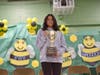 Kirsten Cerdenia, 13, of Burbank, hoists the regional trophy after outspelling South Cook County, for a shot at the National Scripps Spelling Bee, May 26 to May 28.