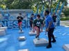 Lamont Doyle, of CholoFit, runs the Moraine Valley cross-country team through the paces on the new outdoor fitness court at the Palos Park Village Green.