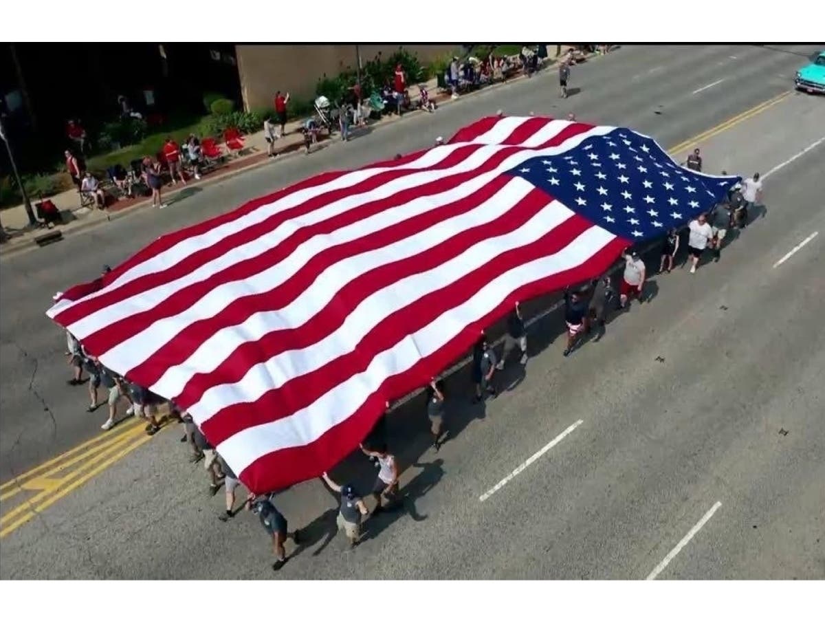 A beautiful drone shot of the 25X50-foot American flag carried by the Oak Lawn Raiders SAC in the annual Independence Day Parade.  