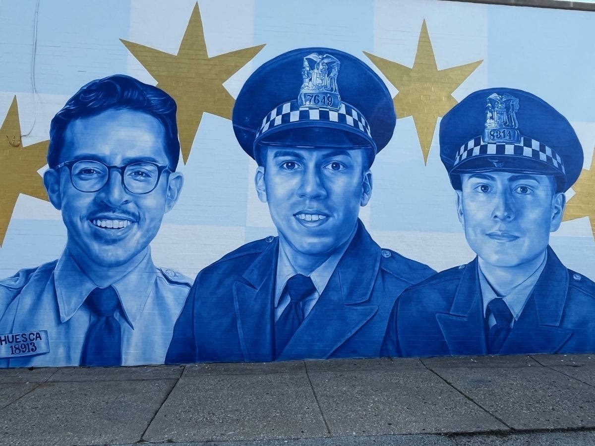 A man has been charged with defacing a memorial honoring fallen Southwest Side police officers in June.
