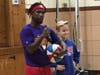 Harlem Wizard James Tyndall tests Washington School student Daniel Vybihal's basketball schools during his Assembly
