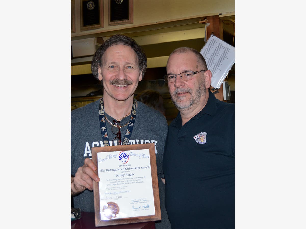 Danny Poggie, owner of Danny's Pizza, accepts the "Elks Distinguished Citizenship Award" from Don Percoski.
