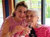 Komen North Jersey Founder Deborah Q. Belfatto leads a champagne toast to Hatcher at the August 4 celebration in her honor at the Fairmount Country Club in Chatham.