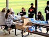 Assembling packets of masks and sanitizer
