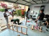 Krishna, Tejas Prakash, Ojas Sathe, Arnav Konda, Pranesh Ragu, and Sukirth Chanda lather the last layer of wood stain onto the first wire shelving unit.