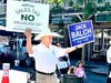 Doug Miller holding signs at the Farmers Market in Pleasanton
