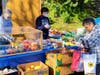 Volunteers for Mama's Pantry at Cameron's Mobile Estates assist residents as they pick out food during the weekly food pantry