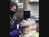 Dream Dinners La Mesa employee Lorna weighs chicken for outgoing meals from Dream Dinners