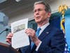 Treasury Secretary Scott Bessent shows of $250 bill design.