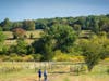 Hikers set out toward David Knights Bridge and preserved bucolic acres of St. Michals Farm Preserve