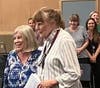 Mary Ellen Kraft (right) is honored by Dr. Howard at a special faculty meeting at Village School.
