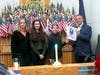 Supervisor Chairman Adam Selisker with the Pavlovcak family placing the Army flag in the display (wife Karen, daughter Kate and son Jack)
